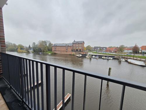 a view of a river with boats in it at Ferienwohnung NorderHafen in Norden