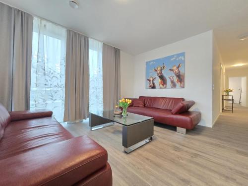 a living room with a couch and a table at Ferienwohnung NorderHafen in Norden