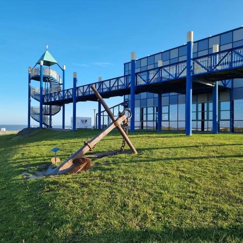 a baseball bat laying on the grass in front of a building at Ferienwohnung NorderHafen in Norden