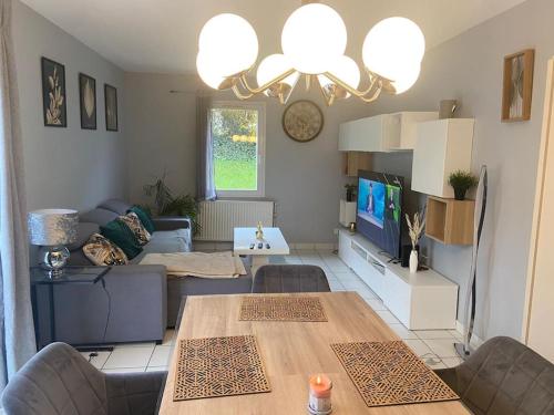 a living room with a couch and a table at Maison proche de vichy in Saint-Rémy-en-Rollat