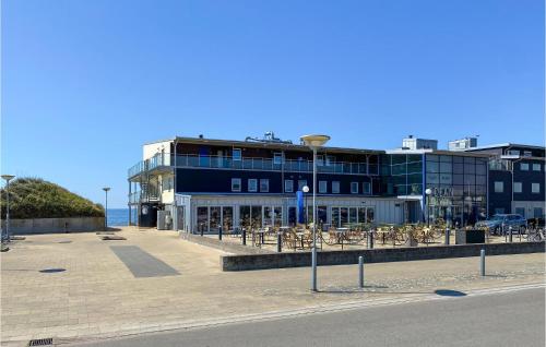a building with tables and chairs in front of it at Awesome Home In Falkenberg in Falkenberg