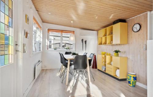 a kitchen and dining room with a table and chairs at Cozy Home In Bjert With Wifi in Binderup Strand