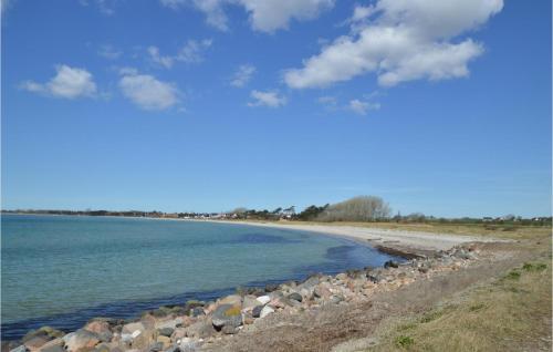 a view of a beach with rocks and the water at Kysthusene, Lejl 25 in Slagelse