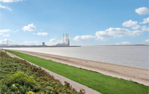 a view of a beach with a building in the distance at Stunning Home In Esbjerg V With Kitchen in Esbjerg