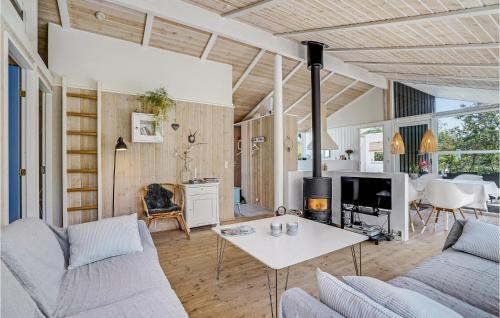 a living room with a couch and a table at Nice Home In Vestervig With Wifi in Hinge