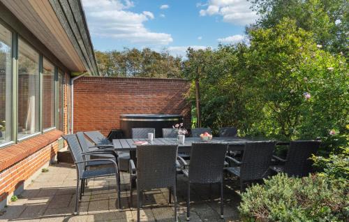 a patio with a table and chairs and a grill at Beautiful Home In Nykøbing M With Wifi in Nykøbing Mors