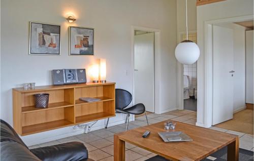 a living room with a couch and a table at 4 Bedroom Lovely Home In Nørre Nebel in Lønne Hede