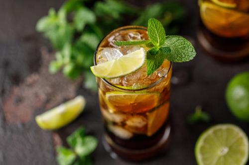 a drink with lime and mint on a table at Garner Hotel Elmshorn by IHG in Elmshorn
