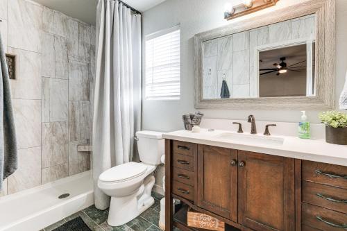 a bathroom with a toilet and a sink and a tub at 3 Mi to London Bridge Home with Patio and Grill! in Lake Havasu City