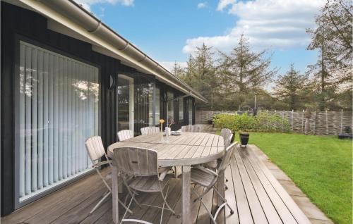 a wooden deck with a table and chairs on it at 4 Bedroom Cozy Home In Skjern in Skjern