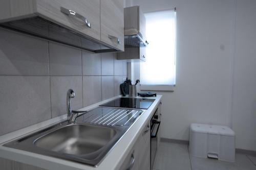a kitchen with a sink and a counter at Capri Residence in Casoria