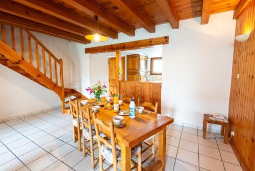 a dining room with a wooden table and chairs at Gîte Gîtes de France 4/6 personnes A in La Fage-Saint-Julien