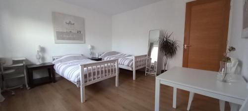 a bedroom with two beds and a desk and a table at B&B luxury villa, free parking, close to the center in The Hague
