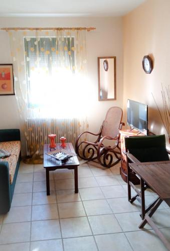 a living room with a couch and a table at Derveni Seaside Apartments - Deluxe Sea View Penthouse Jacuzzi-BBQ & Groundfloor Garden View Apartment in Derveni