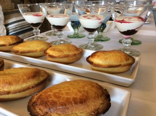 a table with two trays of biscuits and glasses of wine at Palazzo Muro Leccese Relais de Charme & Wellness in Muro Leccese