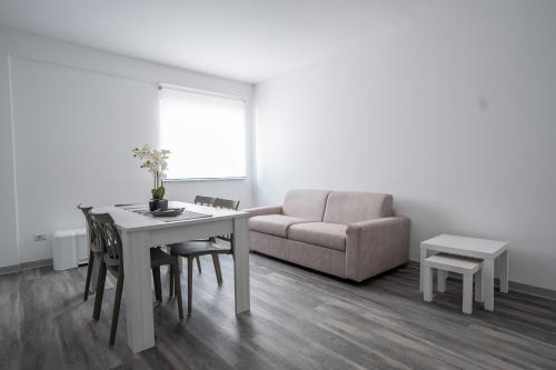 a living room with a table and a couch at Capri Residence in Casoria