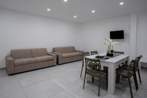 a living room with a table and a couch at Capri Residence in Casoria