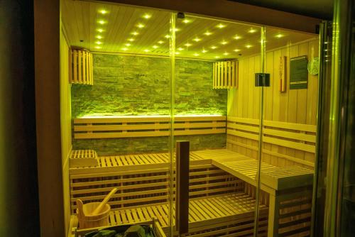 a sauna with a glass door with lights in it at Hotel am Prinzengarten, inklusive AlbCard in Sigmaringen