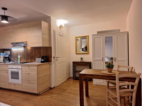 a kitchen with a table and a dining room at Dorf.Apart in Neustift im Stubaital