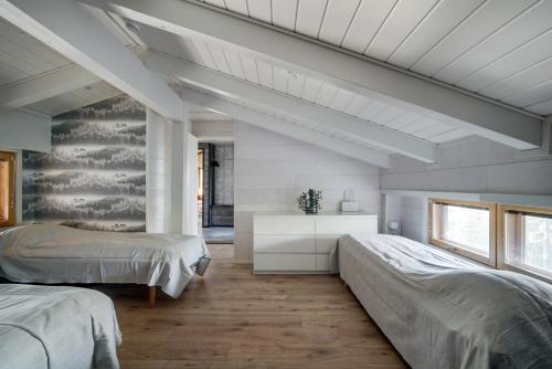 En eller flere senge i et værelse på Villa Metsanhenki Himos