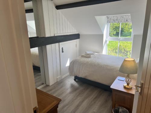 Voodi või voodid majutusasutuse Stables Cottage toas