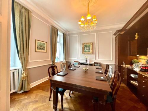 a dining room with a long table and chairs at Hotel Der Kleine Prinz in Baden-Baden
