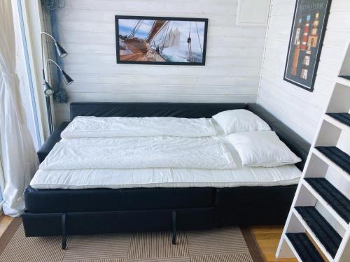 a bed in a corner of a room at Strandstugan, Solviken in Rockneby