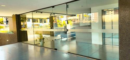 a lobby of a building with a potted plant at Hamptons João Pessoal in João Pessoa