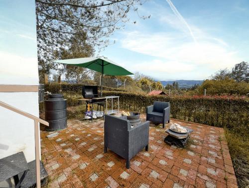a patio with a table and an umbrella and chairs at Rancho Las Santas in Guasca