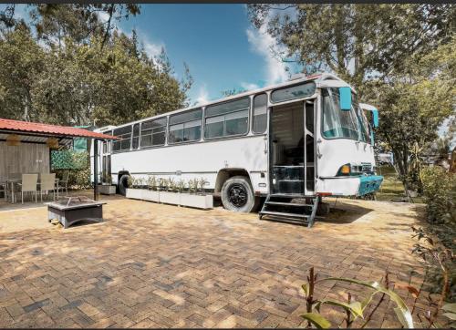 a white bus parked in a parking lot at Rancho Las Santas in Guasca