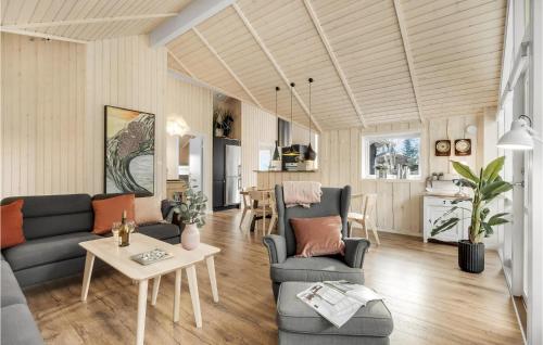 a living room with a couch and a table at Three-Bedroom Holiday Home In Knebel in Knebel