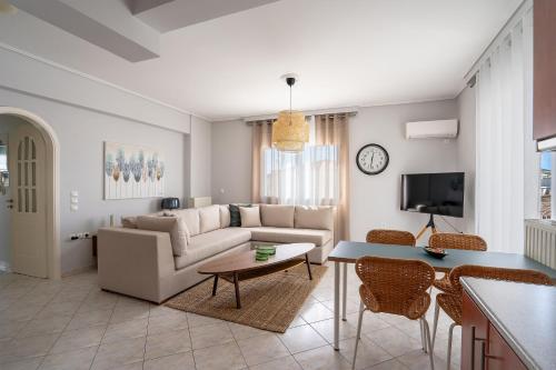 a living room with a couch and a table at Luxury apt near the airport N2 in Spáta