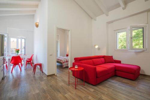 a living room with a red couch and a table at Appartamenti Luna - Stresa in Stresa