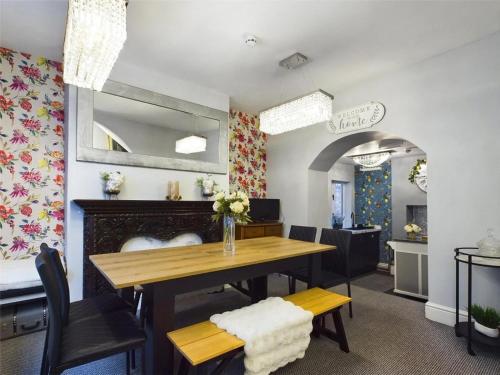 a dining room with a table and a fireplace at Montague House Town Centre Sleeps Up To 12 Guests in Ross on Wye