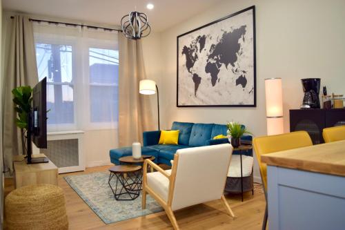 a living room with a blue couch and a table at Newly Renovated 1 Bedroom Executive Apartment in Kearny