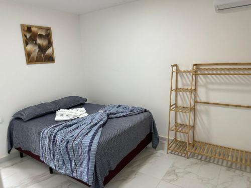 a bedroom with a bed and a metal ladder at Flat no Condominio Home Duplex Bezerros in Bezerros