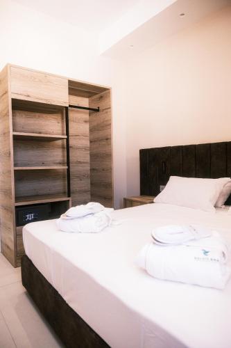 a bedroom with a bed with two towels on it at Relais Ena in Gallipoli