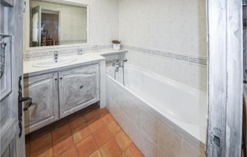 a white bathroom with a tub and a sink at Nice Home In Venasque With Kitchen in Venasque