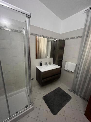 a bathroom with a sink and a shower at Deluxe House of Loto's in Fiumicino