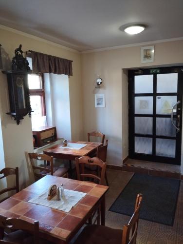 a dining room with wooden tables and chairs at Restaurace a penzion Vlčí jáma in Horní Blatná
