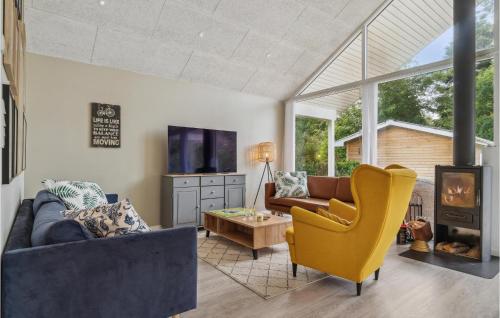 a living room with a couch and a chair at Stunning Home In Jægerspris With Wifi in Jægerspris