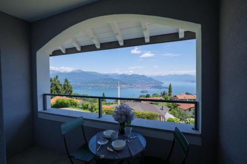 a window with a table and a view of a lake at Appartamenti Luna - Stresa in Stresa