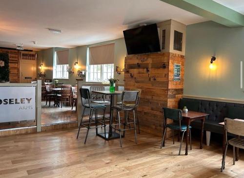 a restaurant with tables and chairs and a tv on the wall at The Moseley Arms in Birmingham
