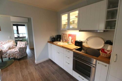 a kitchen with a sink and a counter top at Ferienhaus _GlueckSEEligkeit_ in Großkoschen