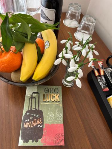 a bowl of fruit on a table with a good luck sign at Kralev Dvor Hotel in Bansko