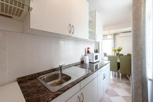a kitchen with a sink and a microwave at Villa Nick in Cavtat