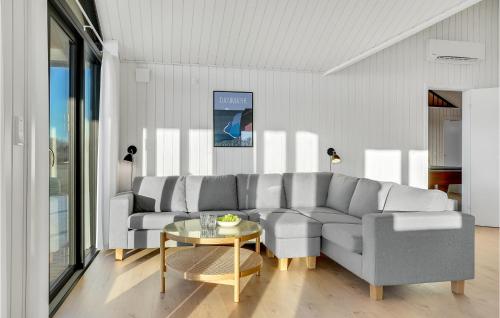 a living room with a couch and a table at Amazing Home In Hørve With Sauna in Hørve