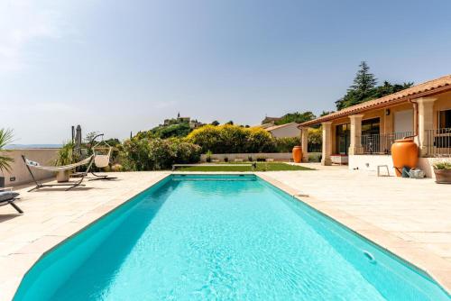 a swimming pool in the backyard of a house at Villa L'ecrin Du Ventoux in Crillon-le-Brave