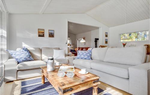 a living room with a white couch and a coffee table at 2 Bedroom Beautiful Home In Gilleleje in Gilleleje