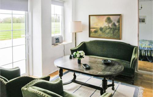 a living room with a couch and a table and chairs at Holiday Home Bakkegårdsvej in Arup